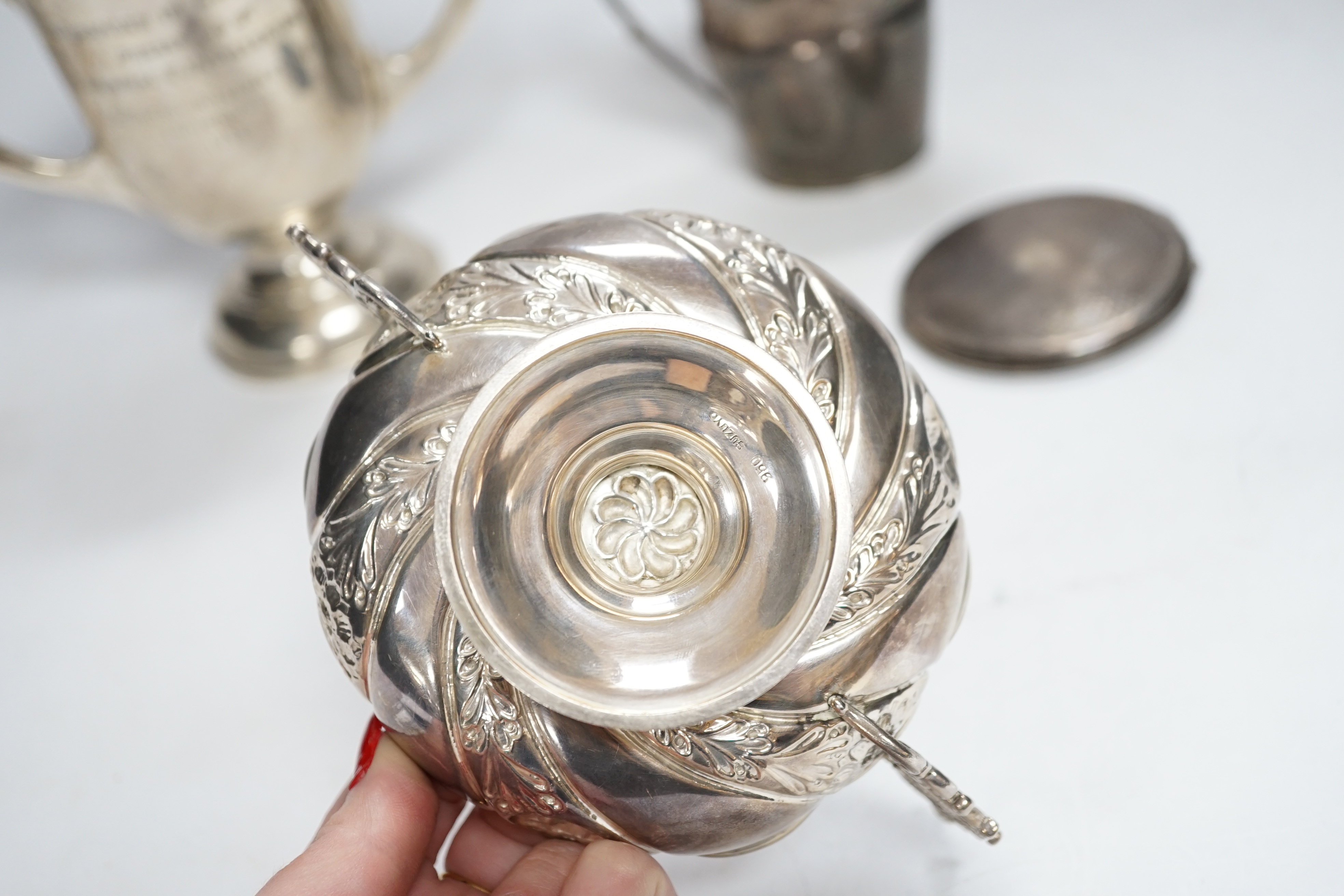 A George III engraved silver helmet shaped cream jug, John Eames, London, 1798, 11.1cm, a Japanese Suzuyo 950 white metal two handled shallow bowl, a George V silver two handled presentation trophy cup and a silver circu